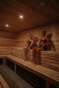 people are relaxing in a wooden sauna, in kuul club.