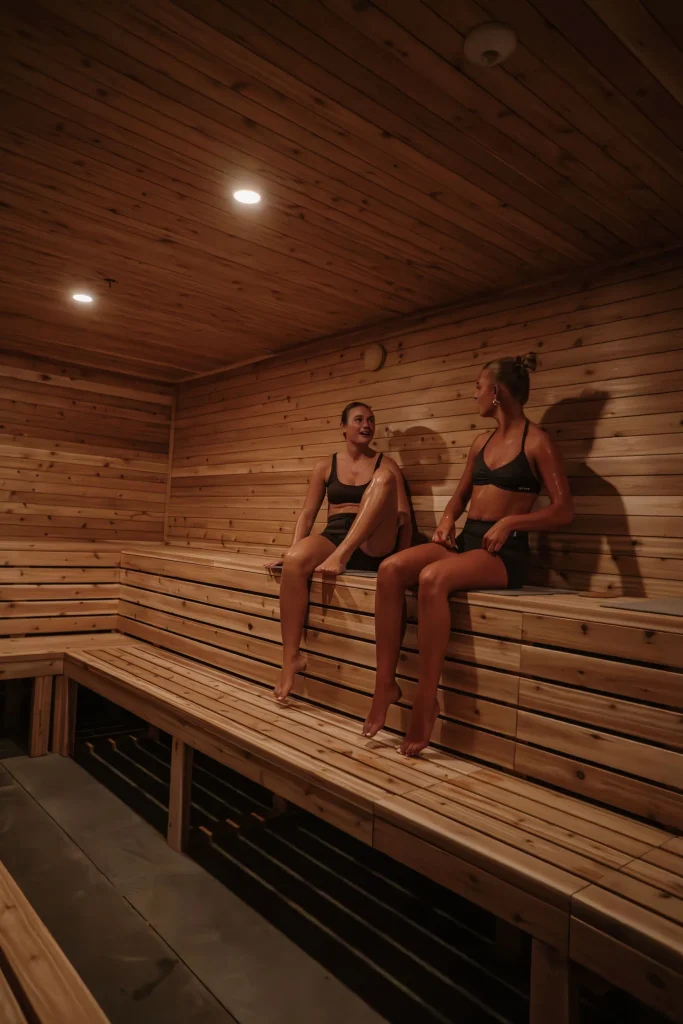 people are relaxing in a wooden sauna, in kuul club.